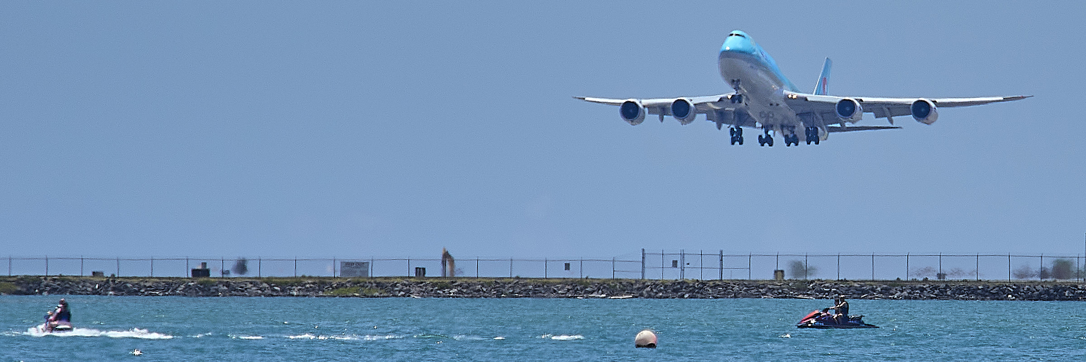 Jet Skiers indulge themselves as jets carrying tourists back home took off from the Reef Runway