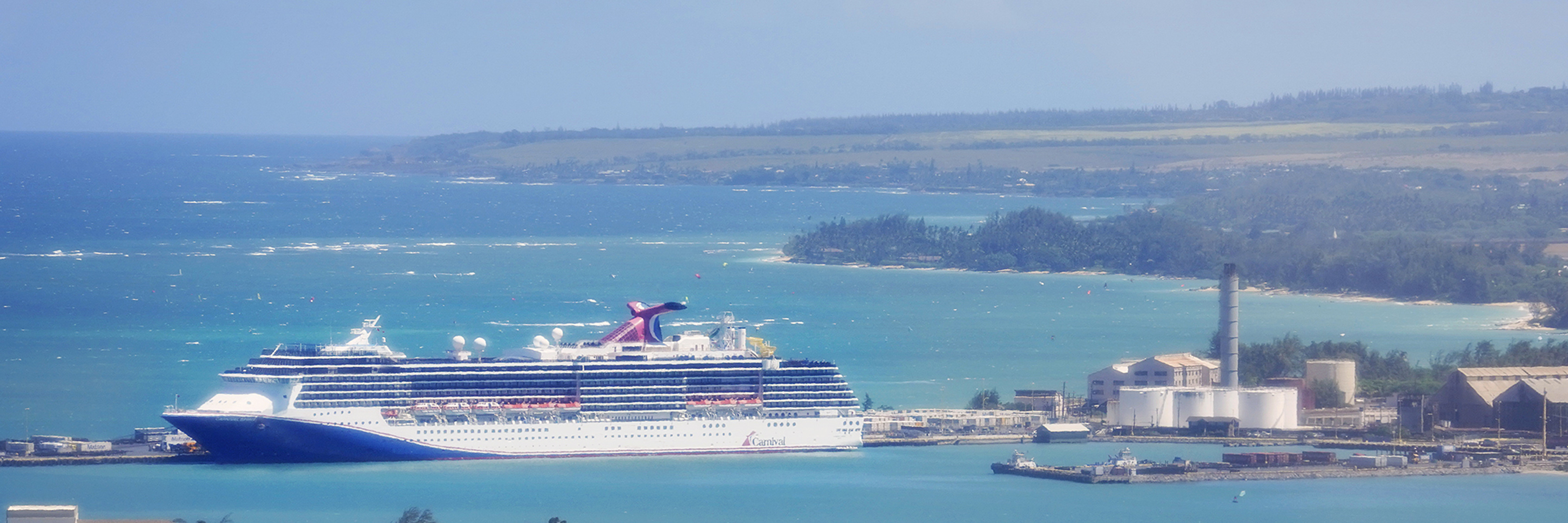 A Norwegian Cruise Line ship sits at anchor at Kahului Port
